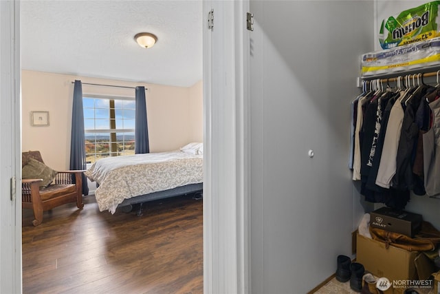 bedroom featuring a textured ceiling and wood finished floors