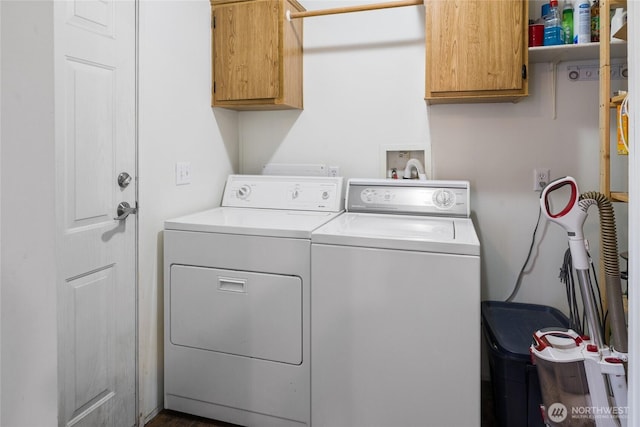 washroom with washing machine and dryer and cabinet space