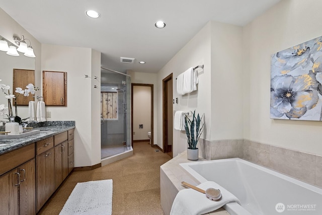 bathroom with visible vents, a garden tub, recessed lighting, a stall shower, and vanity