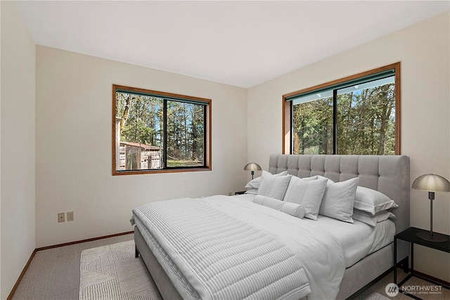 carpeted bedroom featuring baseboards