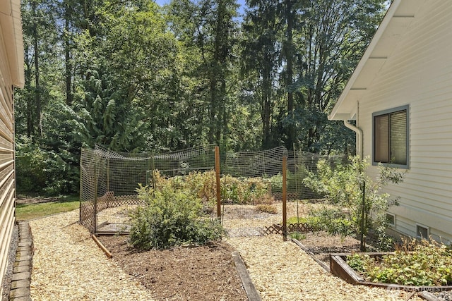 view of yard with a garden and fence