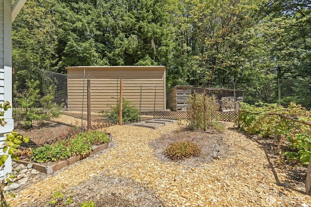 view of yard with a vegetable garden and fence