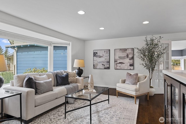 living area with recessed lighting, baseboards, and wood finished floors