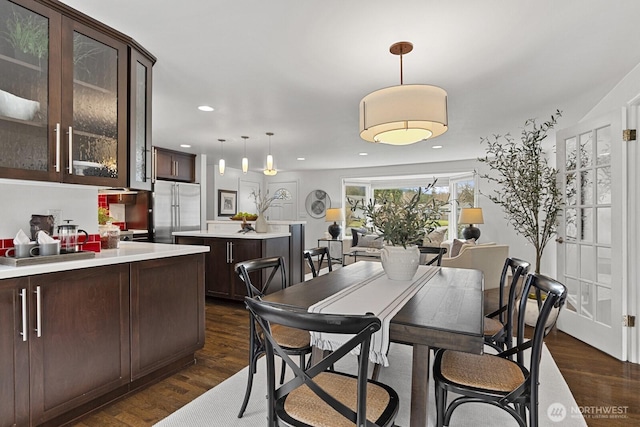 dining room with dark wood-type flooring and recessed lighting