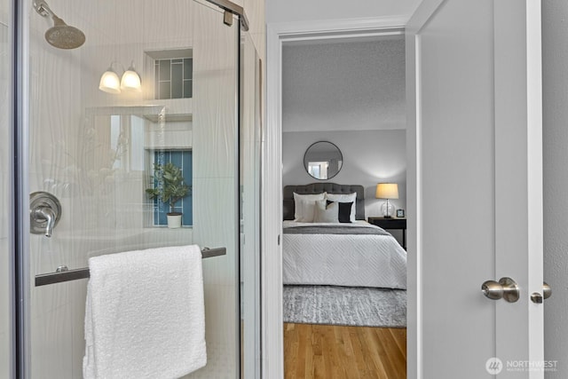 bedroom with a textured ceiling and wood finished floors