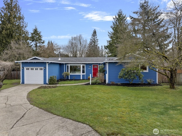 ranch-style home with a front lawn, concrete driveway, an attached garage, and fence