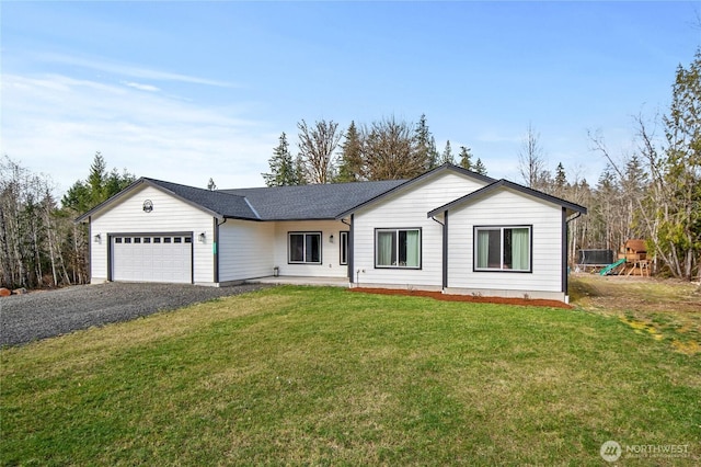 ranch-style home with a garage, driveway, a front lawn, and a playground