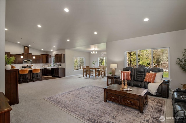 living room with recessed lighting, light colored carpet, vaulted ceiling, and baseboards