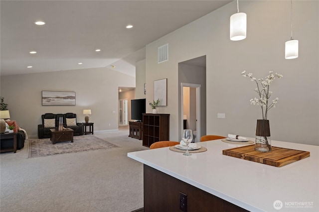 kitchen with visible vents, lofted ceiling, light countertops, carpet floors, and recessed lighting