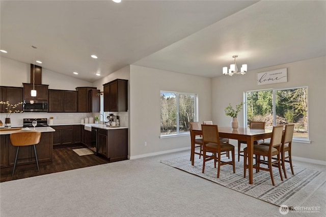 dining room with baseboards, an inviting chandelier, vaulted ceiling, dark colored carpet, and recessed lighting