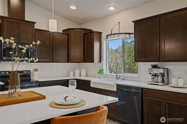 kitchen with stainless steel appliances, tasteful backsplash, a sink, and light countertops