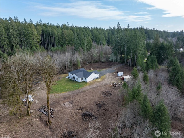 birds eye view of property featuring a view of trees