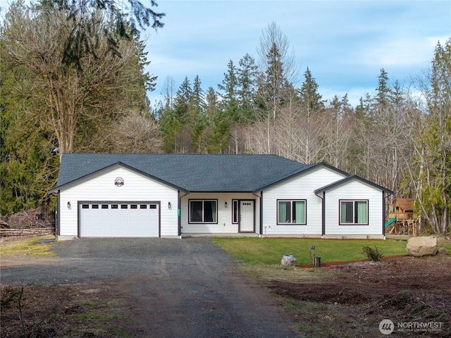 view of front of house featuring a playground, dirt driveway, a shingled roof, an attached garage, and a front lawn