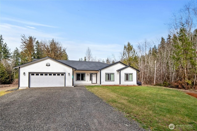 view of front of house with driveway, a front lawn, and an attached garage