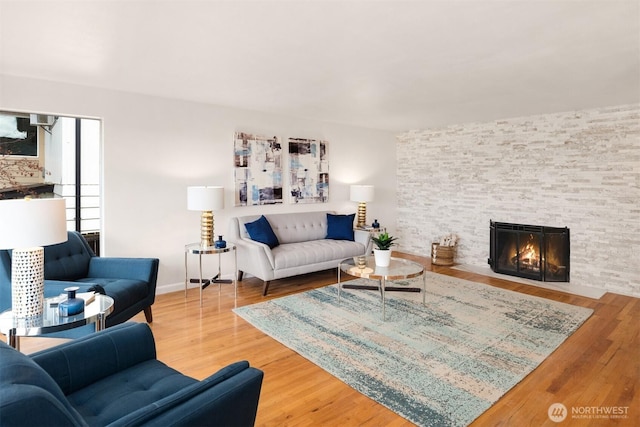 living area featuring a fireplace and wood finished floors