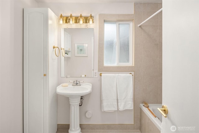 bathroom featuring tiled bath and a tile shower