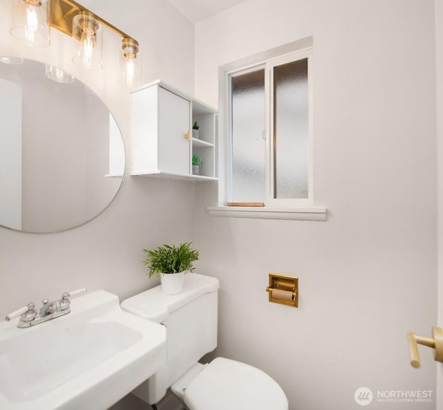 bathroom featuring toilet and a sink