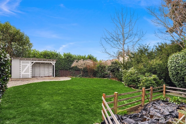 view of yard featuring a storage shed, an outdoor structure, and fence