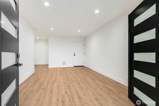 unfurnished room with visible vents, recessed lighting, baseboards, and light wood finished floors