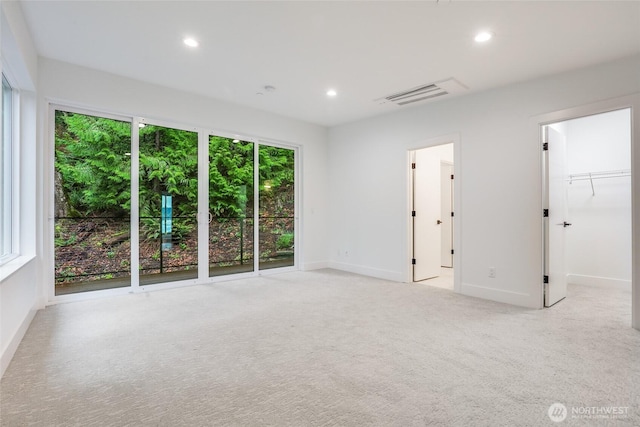 empty room with recessed lighting, visible vents, baseboards, and carpet