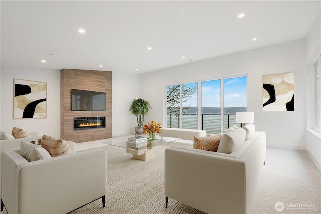 carpeted living room with recessed lighting, a fireplace, and baseboards