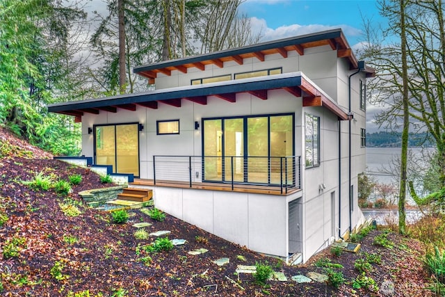 rear view of property with stucco siding