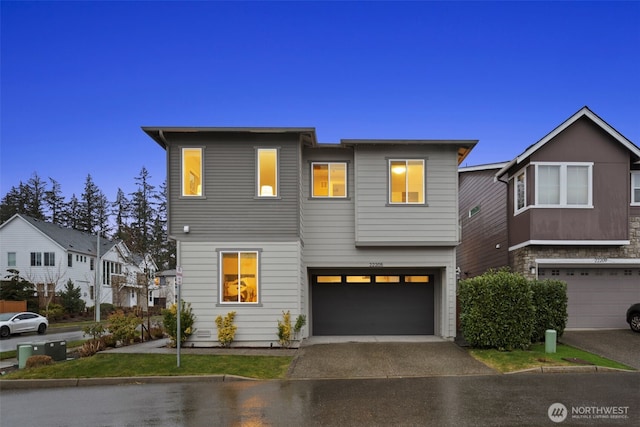 view of front of home with aphalt driveway and an attached garage