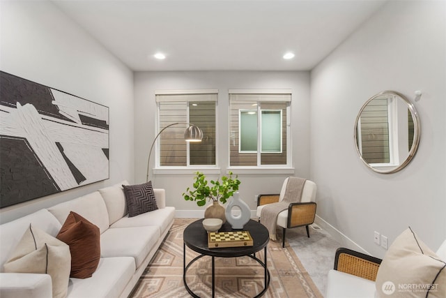 living area featuring recessed lighting and baseboards