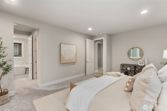 bedroom featuring recessed lighting, light colored carpet, baseboards, and connected bathroom