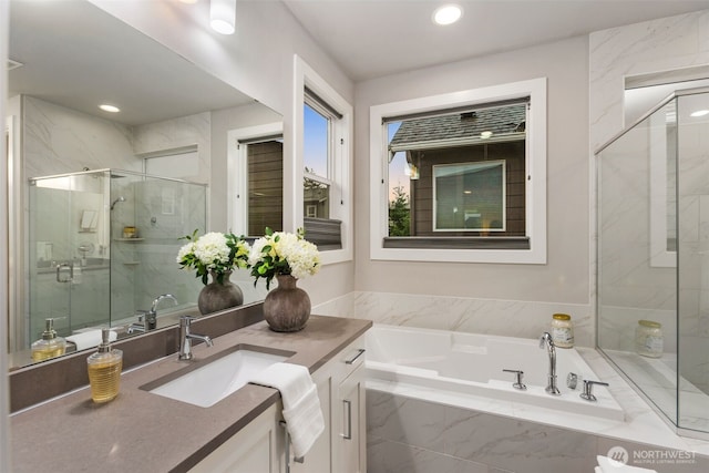 full bath featuring vanity, a garden tub, recessed lighting, and a stall shower