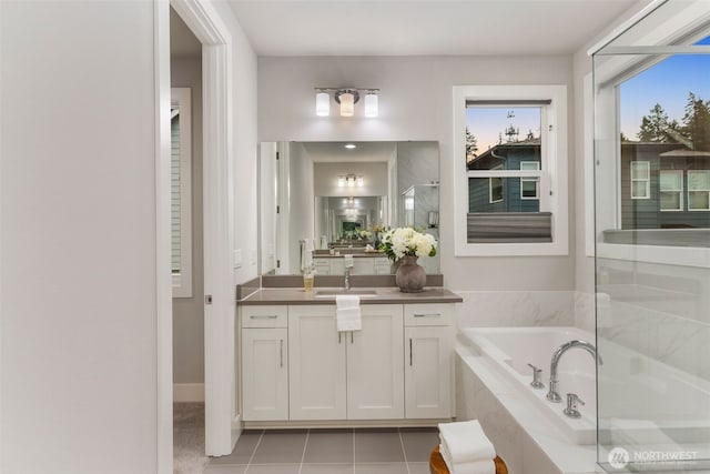 full bath with tile patterned floors, walk in shower, a bath, and vanity