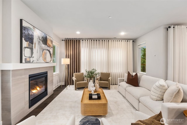 living room featuring recessed lighting, wood finished floors, and a fireplace