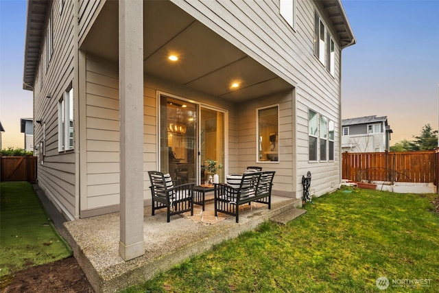 exterior space featuring a patio area, a lawn, and fence