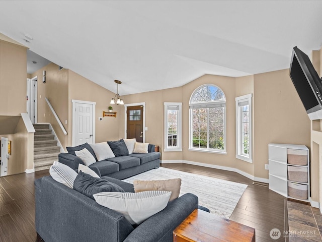 living room featuring a chandelier, dark wood-style flooring, and vaulted ceiling