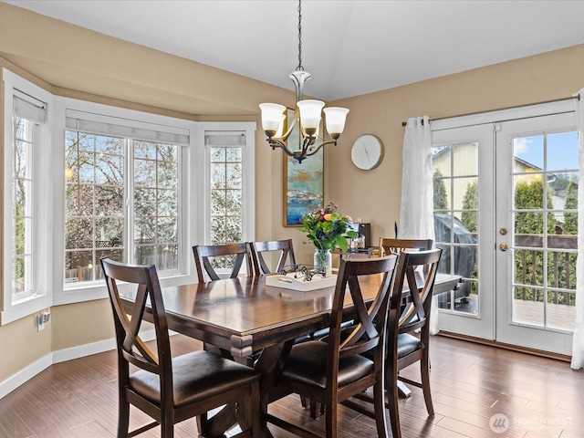 dining area with a wealth of natural light, french doors, and a chandelier