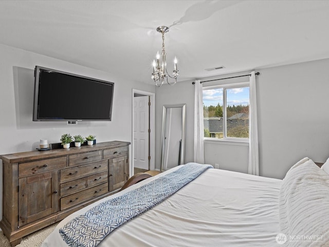 bedroom featuring visible vents and an inviting chandelier