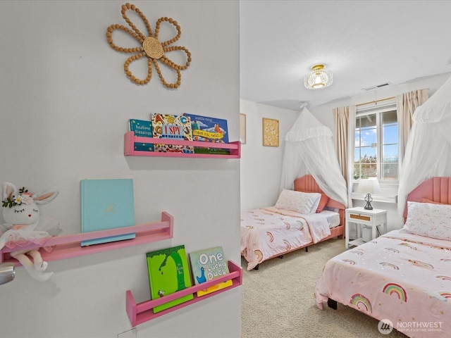 bedroom with visible vents and carpet flooring