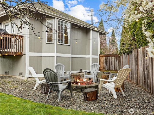 exterior space featuring crawl space, an outdoor fire pit, and fence