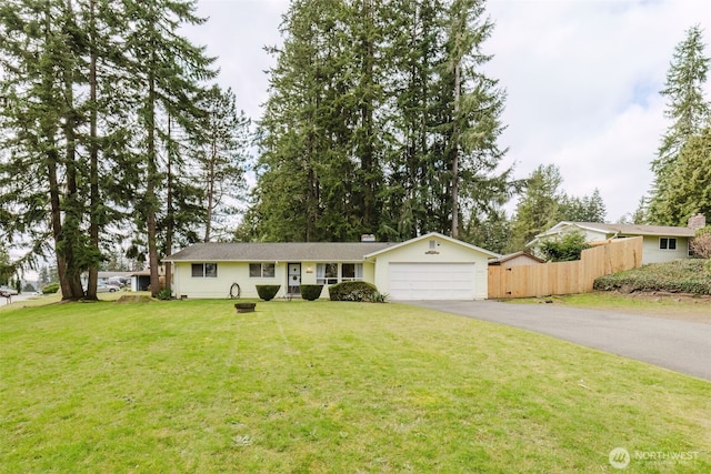 ranch-style home with a front yard, fence, a garage, and driveway