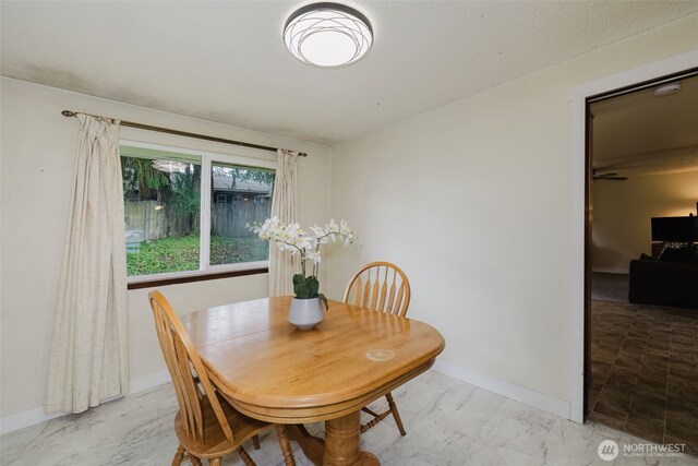 dining room with marble finish floor and baseboards