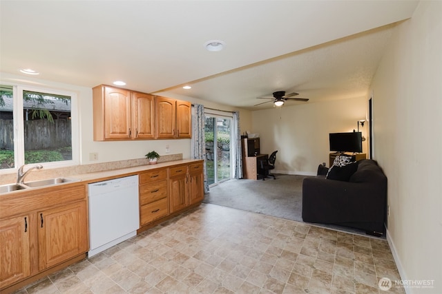 kitchen with a sink, open floor plan, recessed lighting, white dishwasher, and light countertops