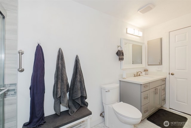 full bath with toilet, vanity, and a shower with shower door