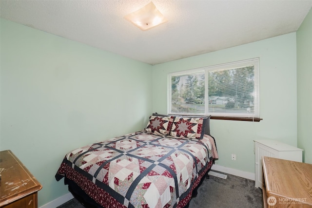 bedroom featuring a textured ceiling, baseboards, and carpet floors