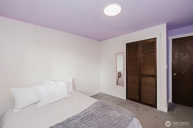 bedroom featuring a closet, baseboards, and carpet