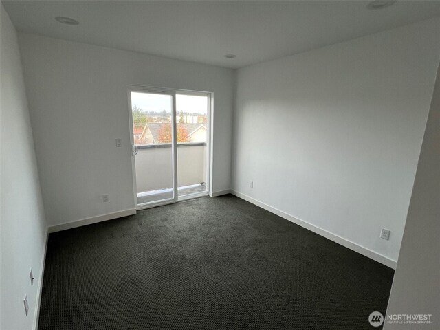 738D N 92nd St, Seattle, WA 98103 - spare room featuring dark carpet and baseboards