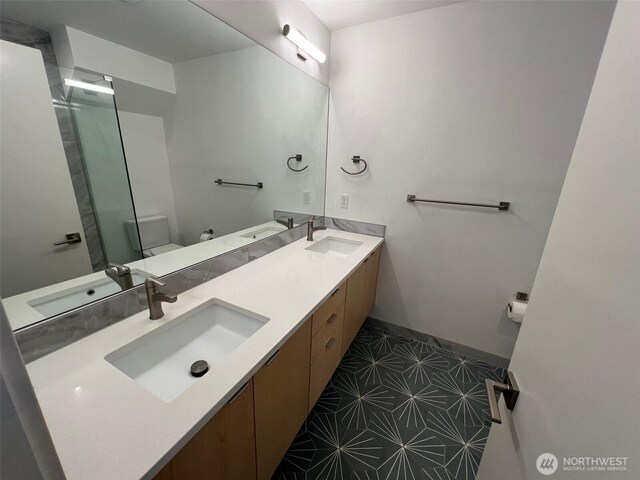 738D N 92nd St, Seattle, WA 98103 - bathroom with double vanity, toilet, tile patterned floors, and baseboards