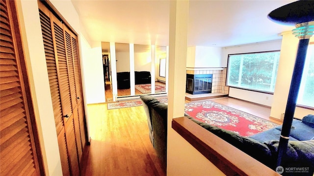 hallway featuring wood finished floors and radiator heating unit