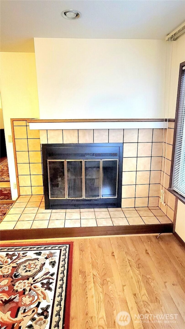 room details featuring a fireplace and wood finished floors