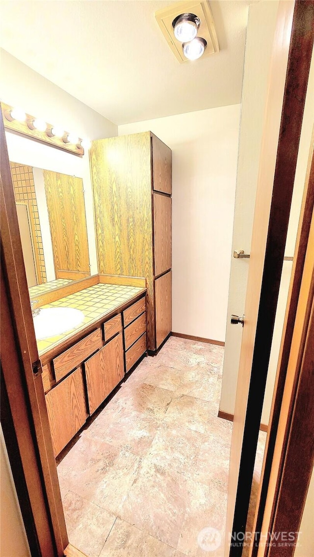 bathroom featuring vanity and baseboards