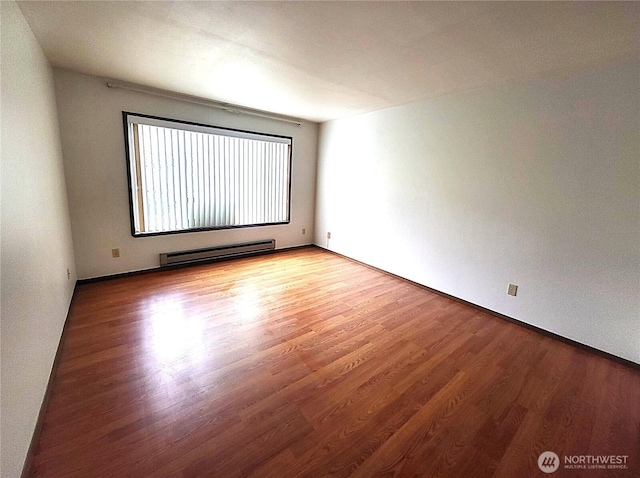 empty room featuring light wood-style flooring and a baseboard radiator